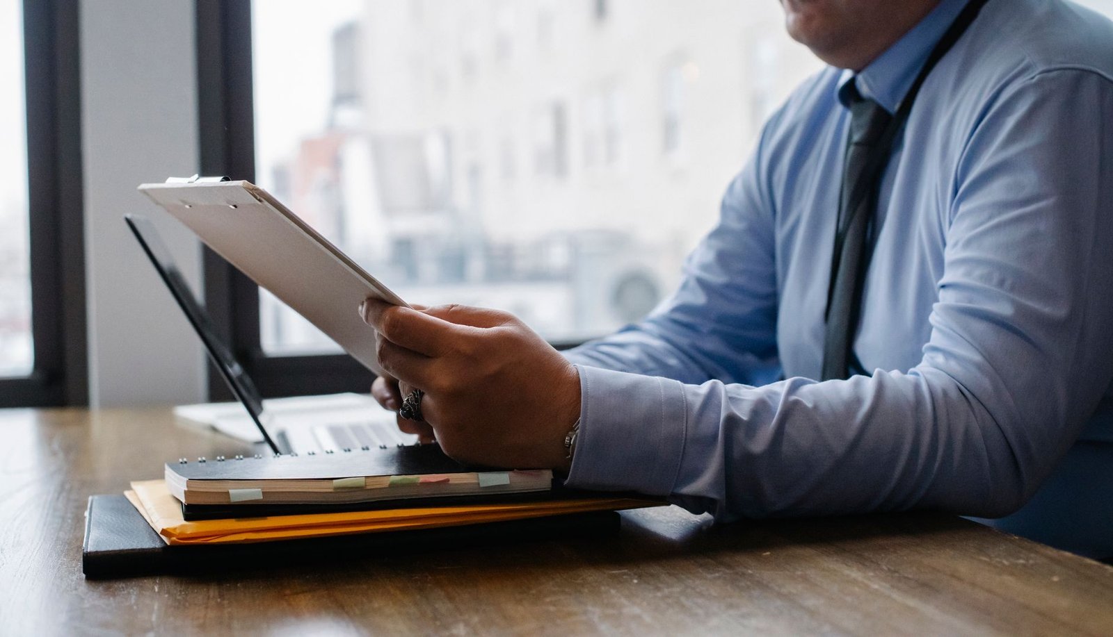Person preparing an ERISA appeal for mental health benefits with plan documents at an organized desk
